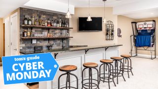 A home bar with five bar stools, a tv, wine rack and two basketball hoops