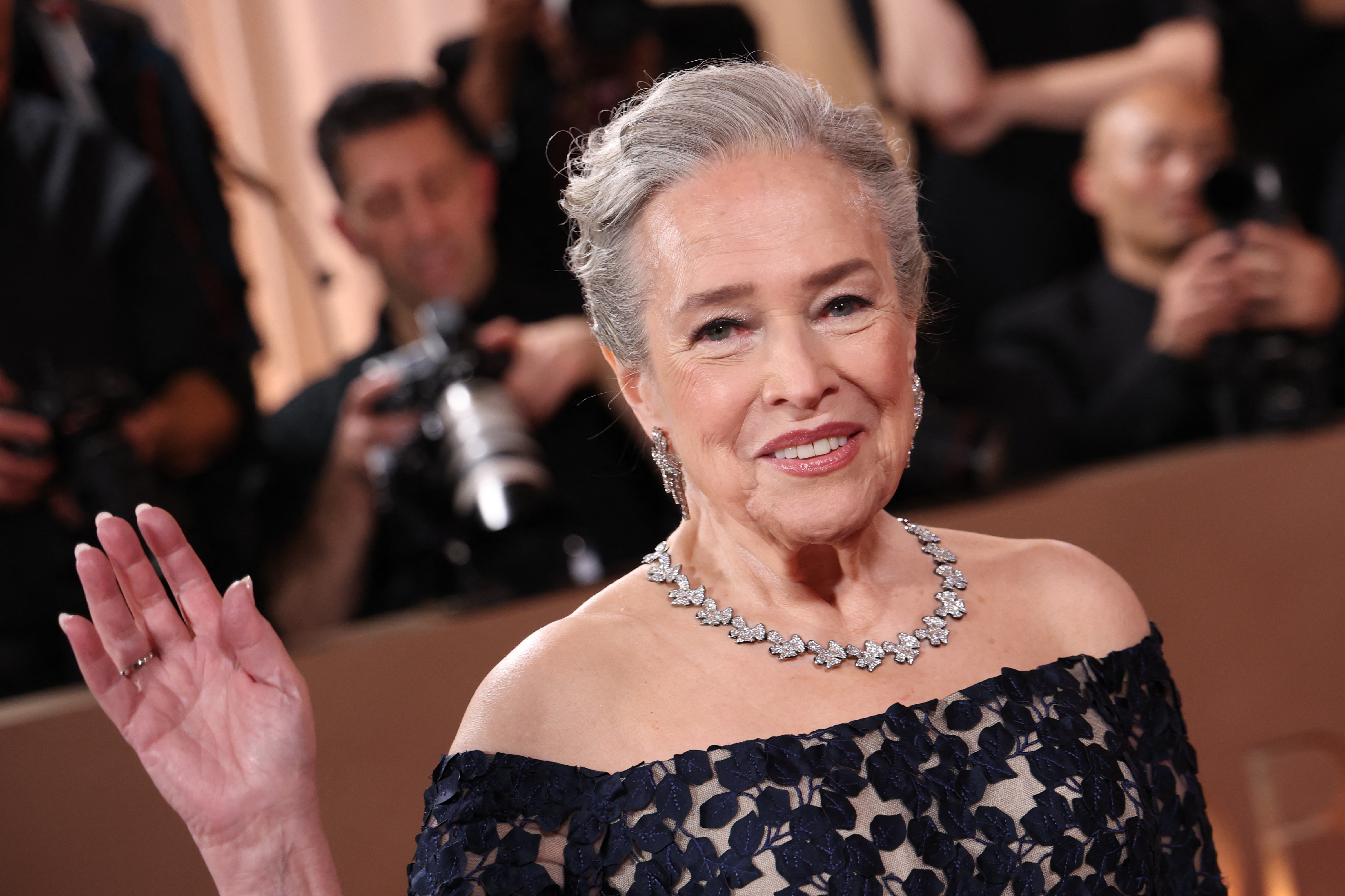 a white woman with gray hair appears on a red carpet