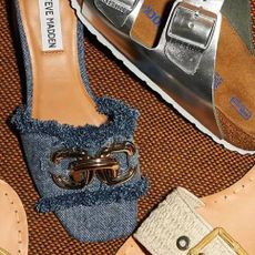 A close up of various shoes including a Birkenstock sandal and a denim slider from Zappos.
