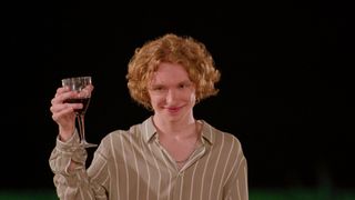 Bryce Lee holding a wine glass.