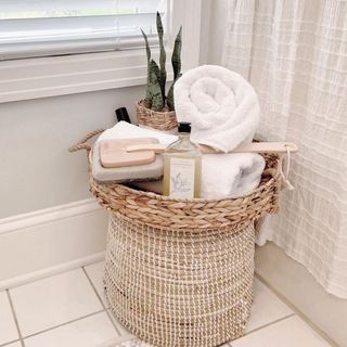 Rustic pamper/spa basket with rolled towels, loofah, and houseplant