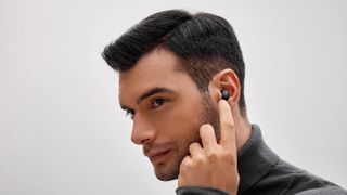 Male model wearing the 1MORE ComfoBuds Mini