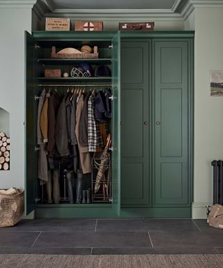 boot room with hooks for coats and closet storage