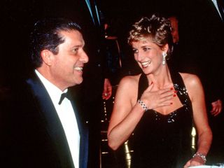 Princess Diana smiles with a guest while dining at the Palace of Versailles for La Deuxieme Nuit International in November 1994