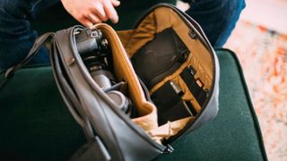 A GoMatic McKinnon Camera Sling 8L being filled with camera kit