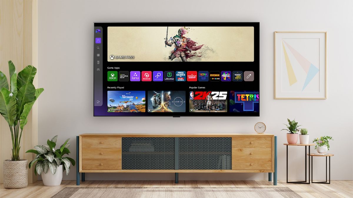 A LG Smart TV hangs on the wall of a well-lit living room, surrounded by house plants. On screen, LG&#039;s touted Gaming Portal can be seen, featuring games such as Avowed, Starfield, and NBA 2K25.