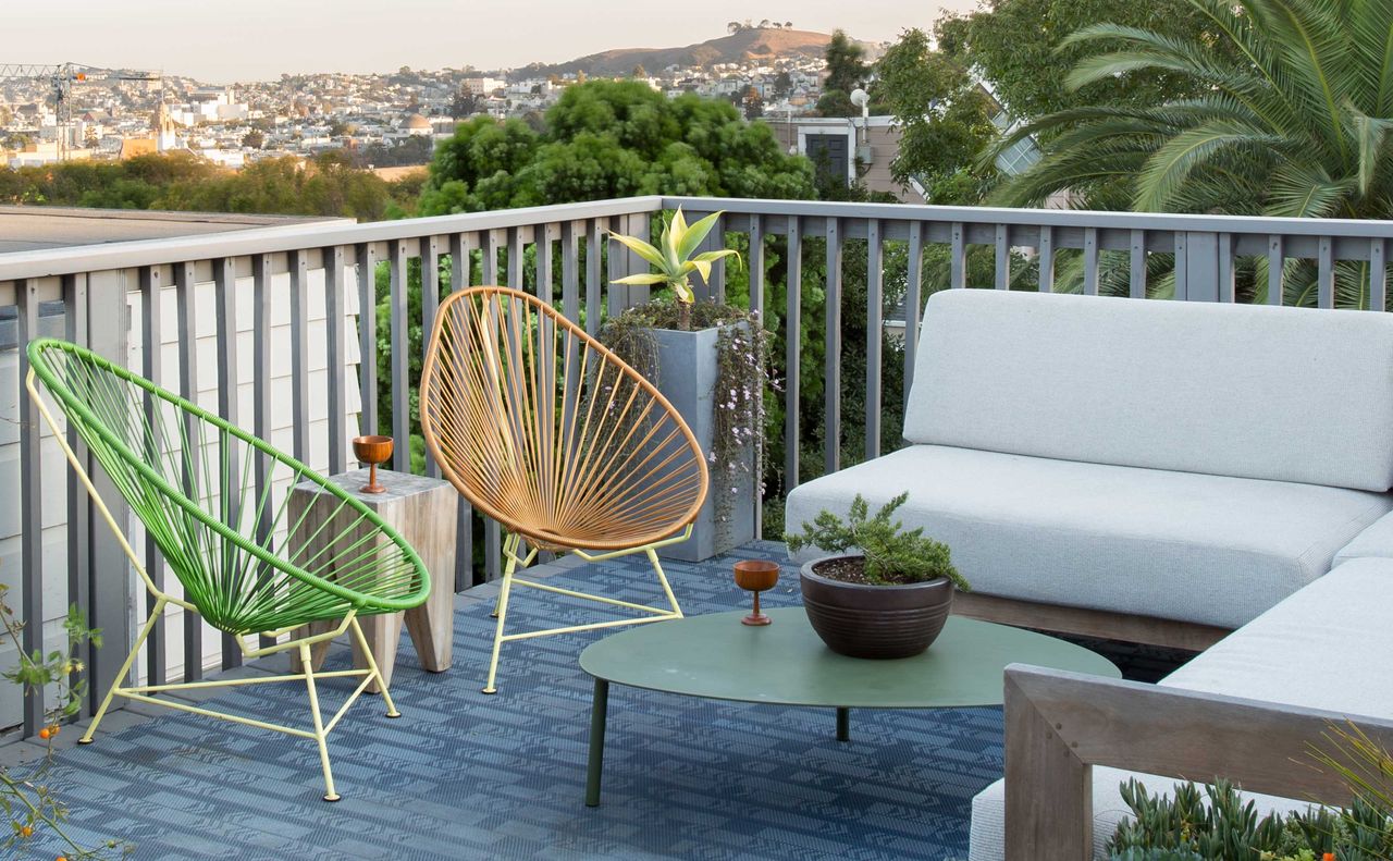 a balcony with colorful chairs on