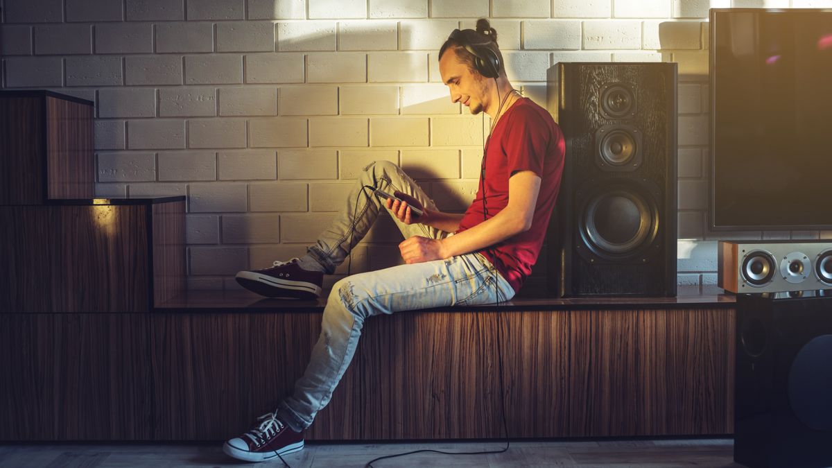 A person enjoying their music in a room full of speakers