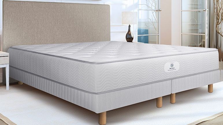 The Sheraton hotel mattress on a box spring in a hotel bedroom