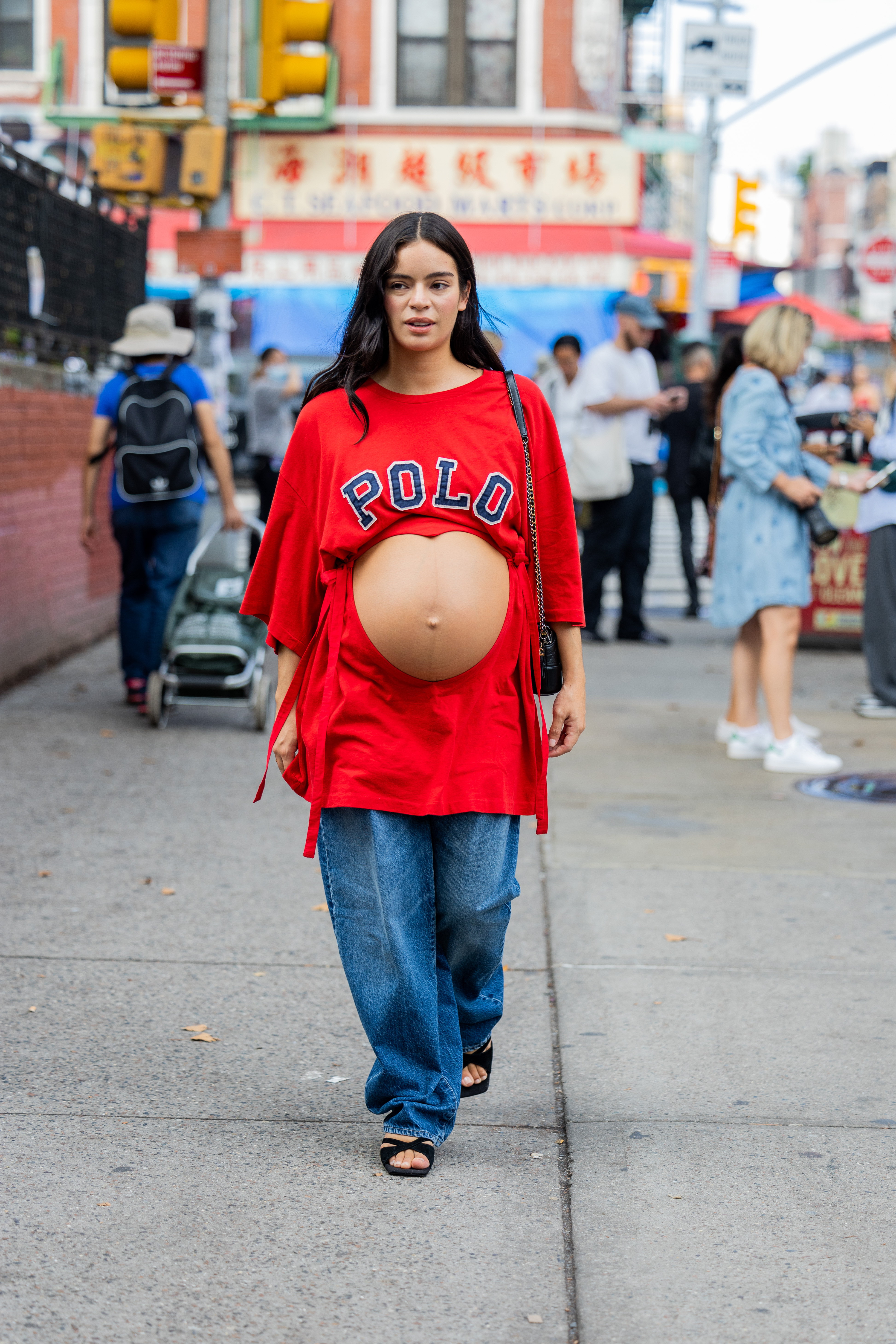 NEW YORK, NEW YORK - SEPTEMBER 12: A pregnant guest wearing cut out red shirt, denim jeans outside Maryam Nassir Zadeh on September 12, 2022 in New York City. (Photo by Christian Vierig/Getty Images)