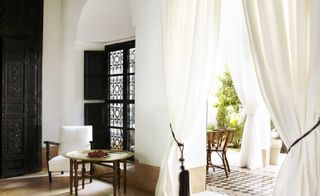 Draped white curtains over door to balcony