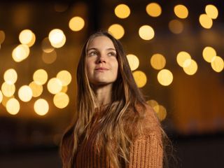 Portait of young woman with blurry night light background, taken with the Viltrox AF 135mm F1.8 lens