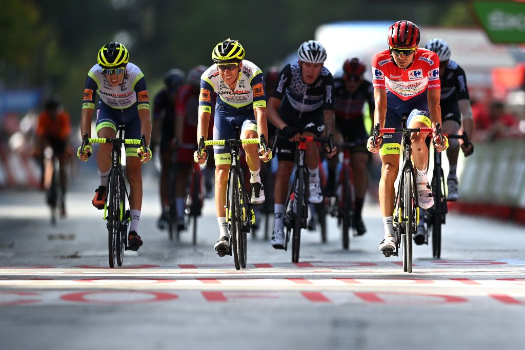 ALBACETE SPAIN AUGUST 18 Rein Taarame of Estonia and Team Intermarch Wanty Gobert Matriaux Red Leader Jersey and Teammates crosse the finishing line during the 76th Tour of Spain 2021 Stage 5 a 1844km stage from Tarancn to Albacete lavuelta LaVuelta21 on August 18 2021 in Albacete Spain Photo by Stuart FranklinGetty Images