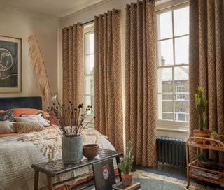 Bedroom in neutral palette with grommet curtains