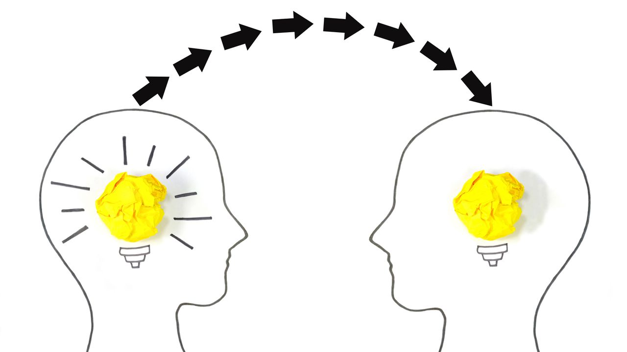 Drawing of the outline of two heads with light bulbs inside