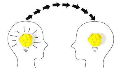 Drawing of the outline of two heads with light bulbs inside