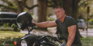 John Cena sits with a motorcycle