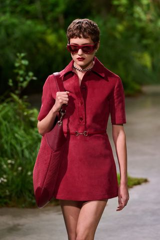 A model on the Gucci catwalk wears a red color trend for fall 2024