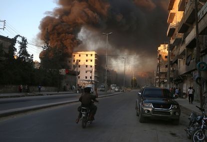 Smoke billows from the rebel-held Salihin neighborhood in Aleppo, Syria.
