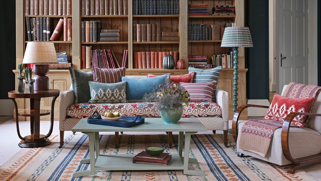 Living room with blankets and pillows on sofas and armchairs