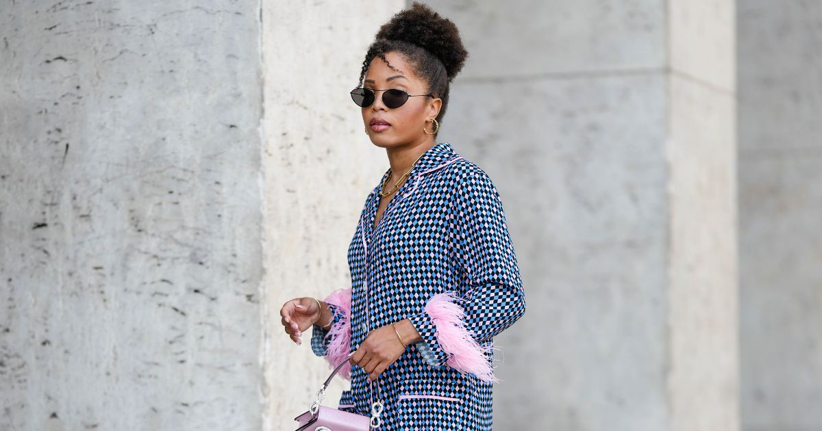 best liquid blusher - woman wearing sunglasses with blue shirt - gettyimages 1498872804