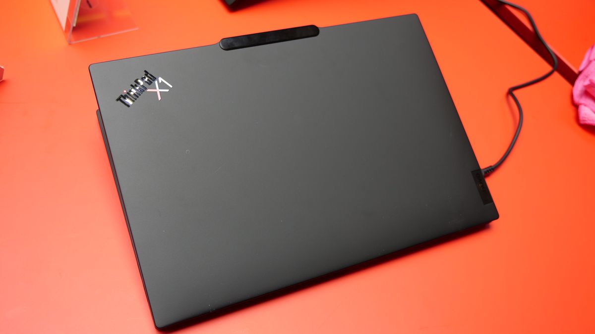 Images of the Lenovo ThinkPad X1 Carbon Gen 13 Aura Edition on a red table at IFA 2024