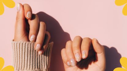 image of hands with glitter nail designs on a pink backdrop