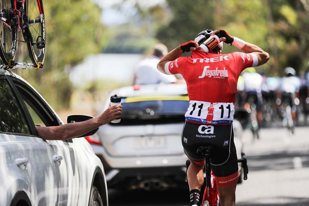 A Trek Segafredo drops back to pick up bottles for his teammates
