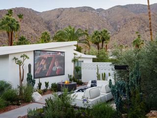 backyard with cinema screen and firepit by Ryan Saghian