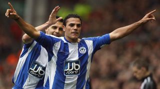 Wigan Athletic's Egyptian forward Amr Zaki (R) is congratulated by Wigan Athletic's Austrian midfielder Paul Scharner after scoring against Liverpool during their English Premier League football match at Anfield in Liverpool, north west England on October 18, 2008. Liverpool won the game 3-2.