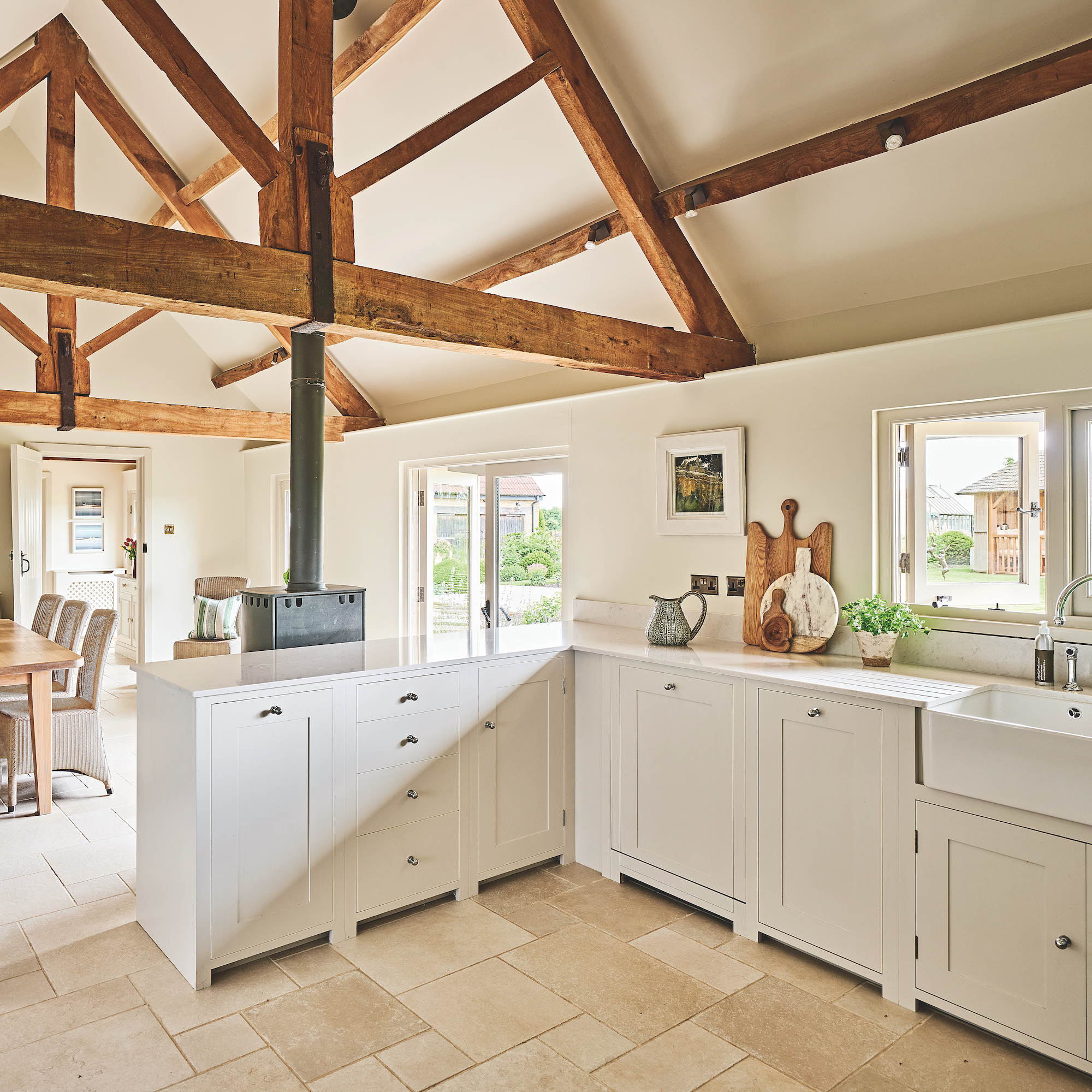 L-shaped kitchen with white cabinetry and butler's sink