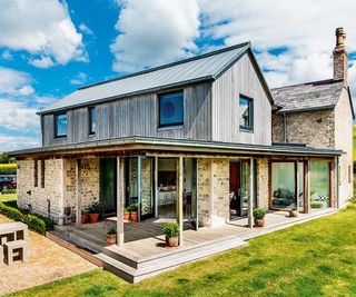 Timber clad double storey extension to an old cottage