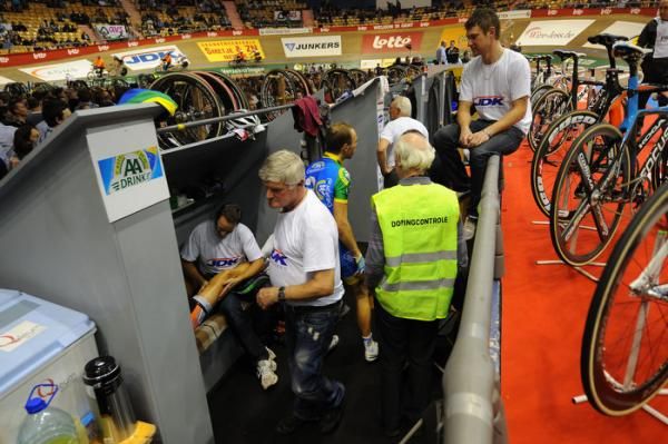 Soigneurs rub legs as the doping control was carried out