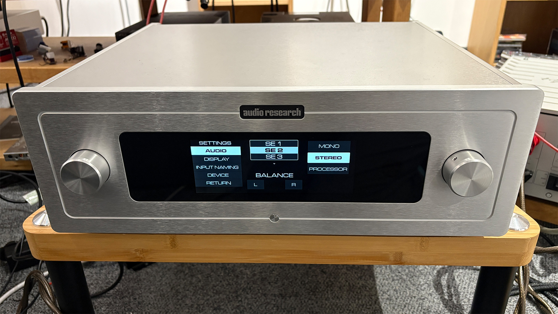 Audio Research LS-2/S-200 preamp on wooden hi-fi rack showing options on display