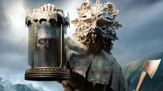 A druid wearing a demonic mask holds up a decaying head in a jar.