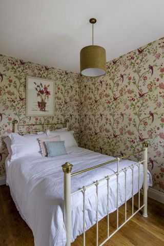 second bedroom with patterned wallpaper