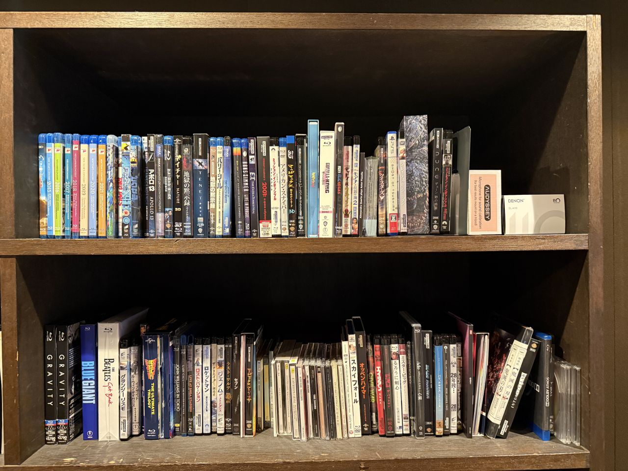 Two shelves full of Blu-ray discs (and some CDs and DVDs)