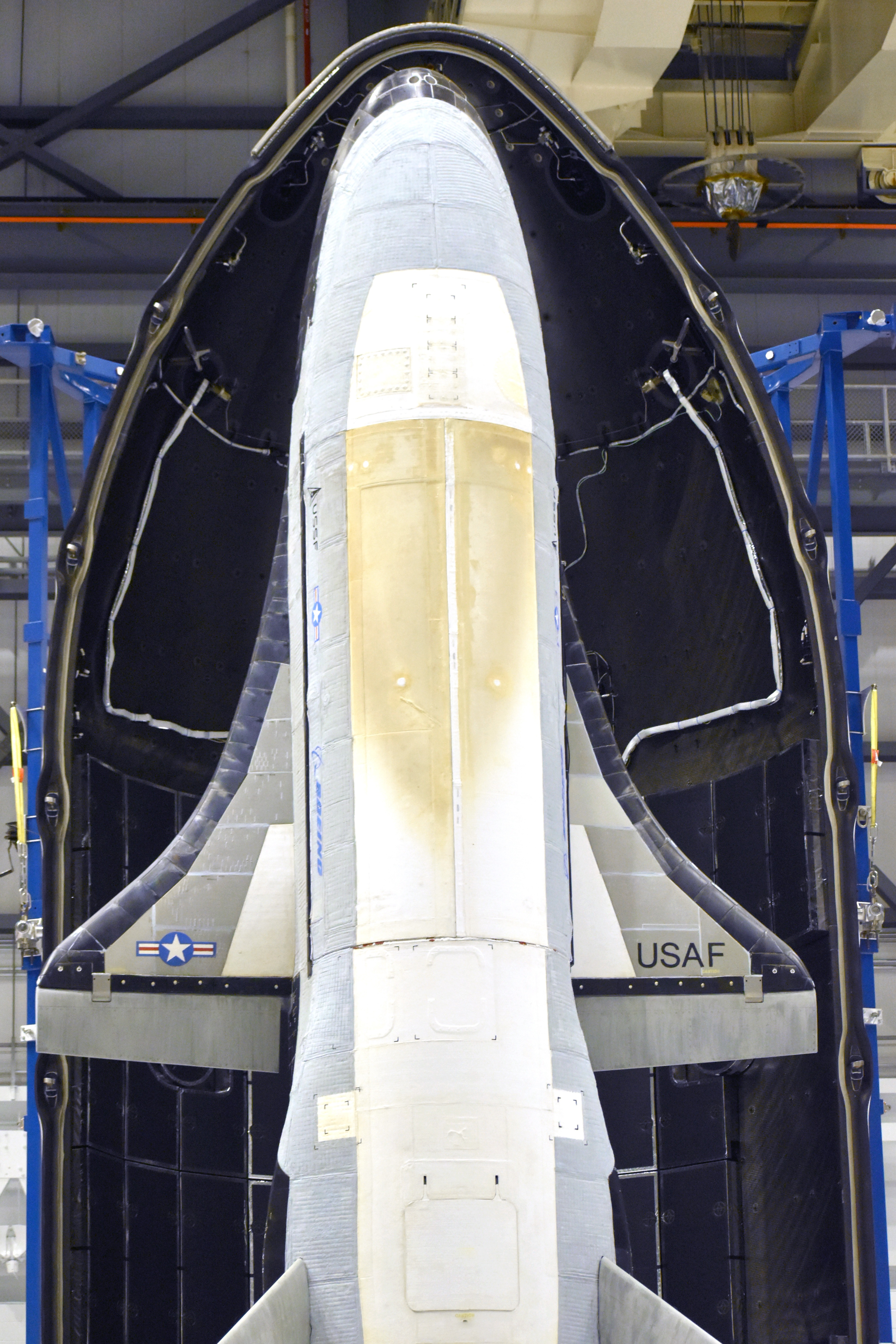 a white aircraft inside of a large egg-shaped pod in a hangar