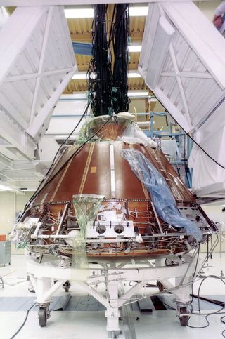 The Apollo 11 command module, no. 107, under construction and testing in 1968 at North American Aviation's factory in Downey, California.