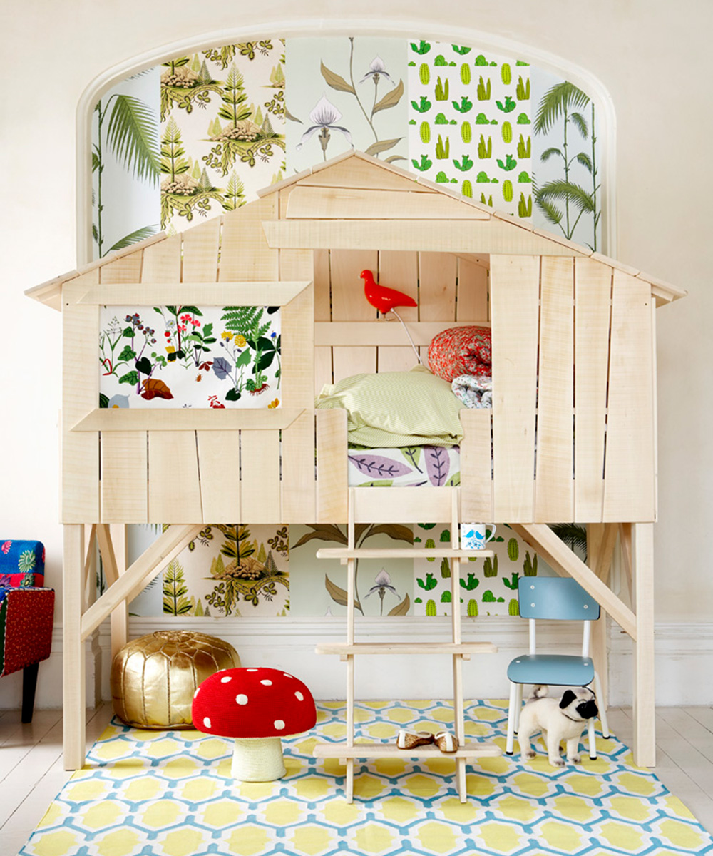 A variety of green and white patterned wallpapers and a bespoke treehouse bed illustrate small bedroom ideas for kids.