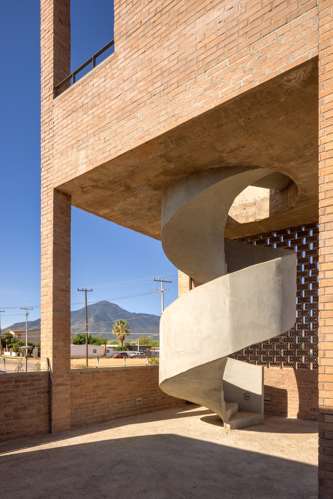 Border Outlook by Fernanda Canales, a brick, textured structure made of vaults and raised platforms