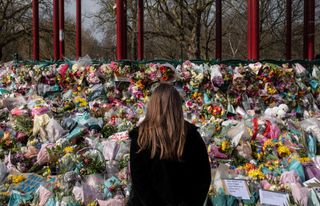 Well wishers look at the floral tributes placed in tribute to Sarah Everard on Clapham Common on March 15, 2021