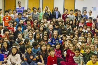 Congressman Adam Schiff and NASA astronaut Tracy Caldwell Dyson take a photo with students at La Crescenta Elementary.