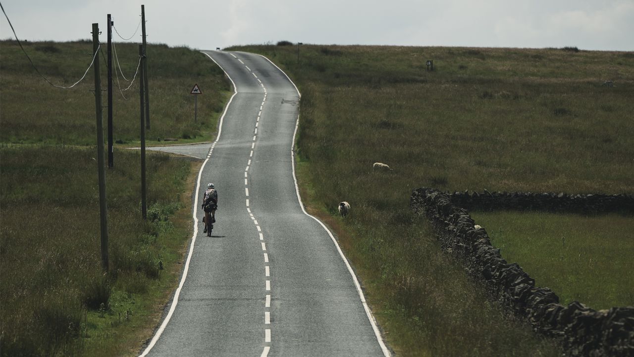 Cyclist riding up a road