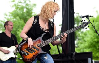 Bassist Lisa Dodd performs onstage during the ACM Party For A Cause Festival at Globe Life Park in Arlington on April 17, 2015 in Arlington, Texas.