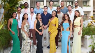 A group picture of this year's sixteen contestants, all facing the camera with big smiles and framed by palm fronds in a promotional shot for Bachelor in Paradise Season 10.