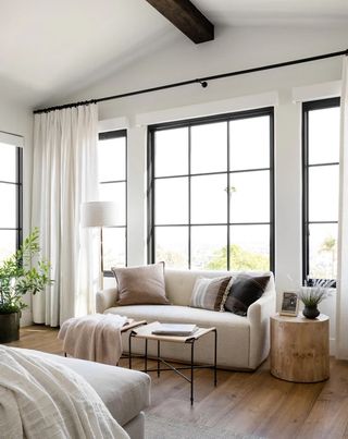 A white sofa in a bedroom