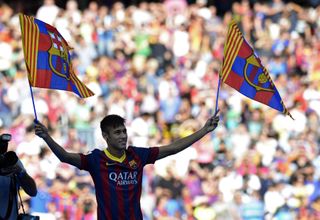 Neymar waves two Barcelona flags at Camp Nou at his official presentation for the Catalan club in June 2013.