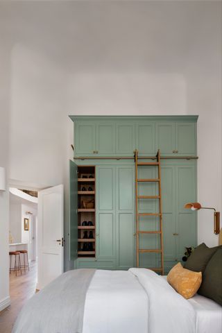 A bedroom with wardrobe till the ceiling