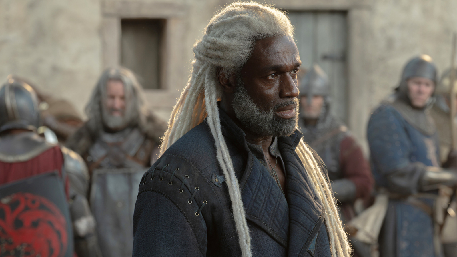 Corlys Velaryon standing outside of the town of Tumbleton in House of the Dragon season 3 episode 8